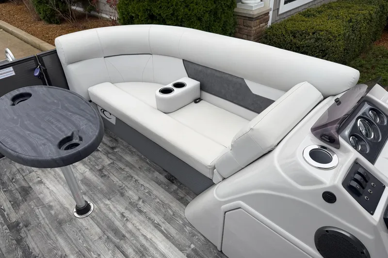 Slide: The Image of 2019 Crest I SLRC boat interior with white seating, table, and control panel. - 11