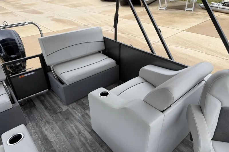 Slide: The Image of 2019 Crest I SLRC pontoon boat interior with gray seating and cup holders. - 13