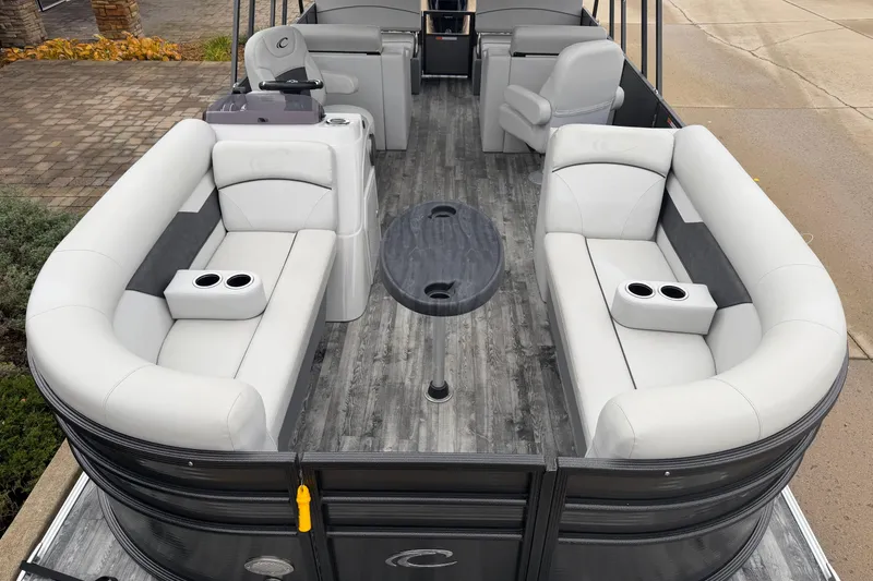 Slide: The Image of 2019 Crest I SLRC pontoon boat interior with plush seating and central table. - 3