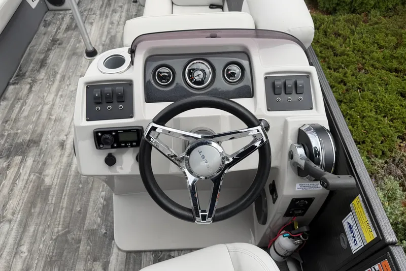 Slide: The Image of 2019 Crest I SLRC boat dashboard with steering wheel, gauges, and controls. - 8