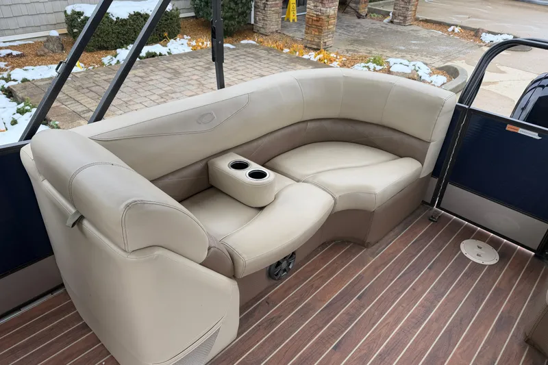 Slide: The Image of Luxurious seating on 2017 Crest 230SL Classic boat with cup holders and wood-style flooring. - 12