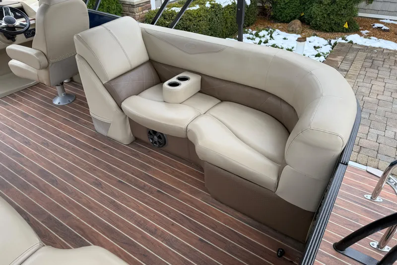 Slide: The Image of Luxurious seating on 2017 Crest 230SL Classic boat with wood-style flooring and cup holders. - 13