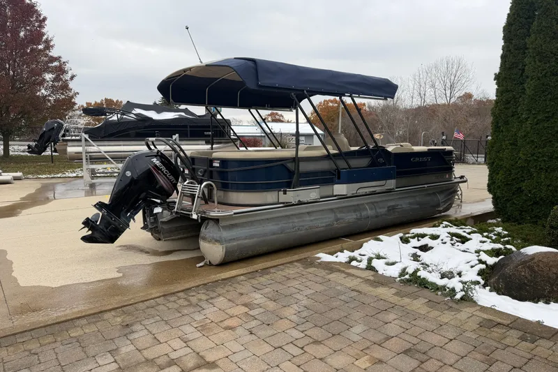 Slide: The Image of 2017 Crest 230SL Classic pontoon boat with canopy, parked on a snowy driveway. - 15