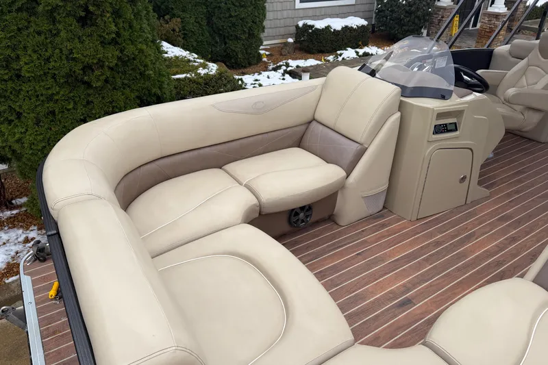 Slide: The Image of 2017 Crest 230SL Classic boat interior with beige seating and wood flooring. - 4