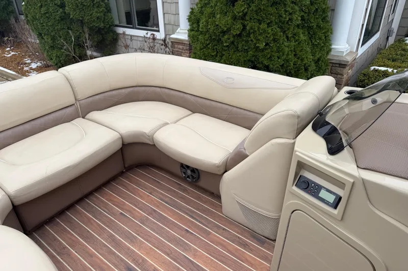 Slide: The Image of Luxurious seating on 2017 Crest 230SL Classic boat with wood flooring and control panel. - 5