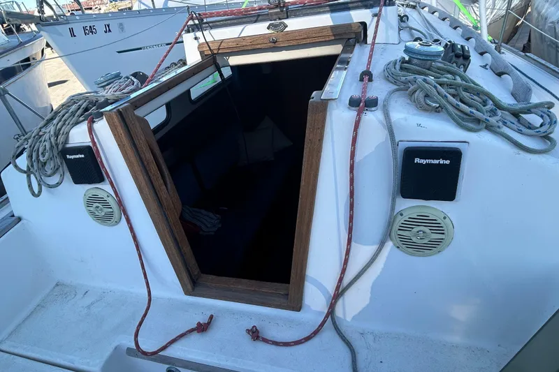 Slide: The Image of 1982 Sabre 30 sailboat cockpit with ropes, speakers, and cabin entrance. - 4