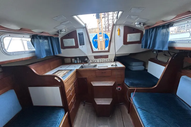 Slide: The Image of Interior of a 1982 Sabre 30 sailboat with wood finish and blue upholstery. - 9