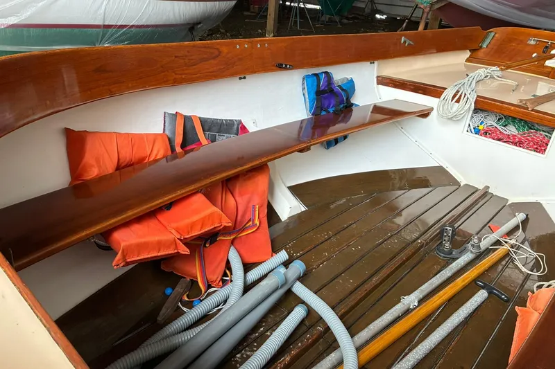 Slide: The Image of 1981 Herreshoff Doughdish 12.5 footer interior with life jackets and sailing equipment. - 18