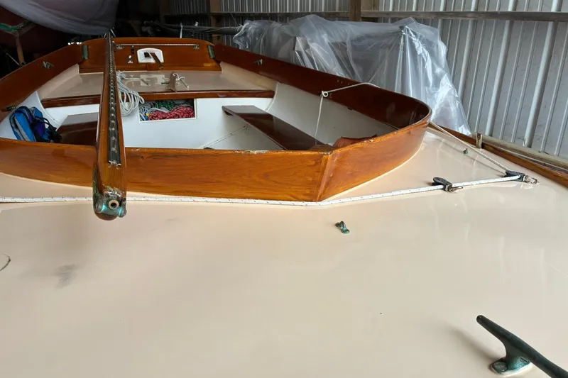 Slide: The Image of 1981 Herreshoff Doughdish 12.5 footer sailboat with wooden details in storage. - 4
