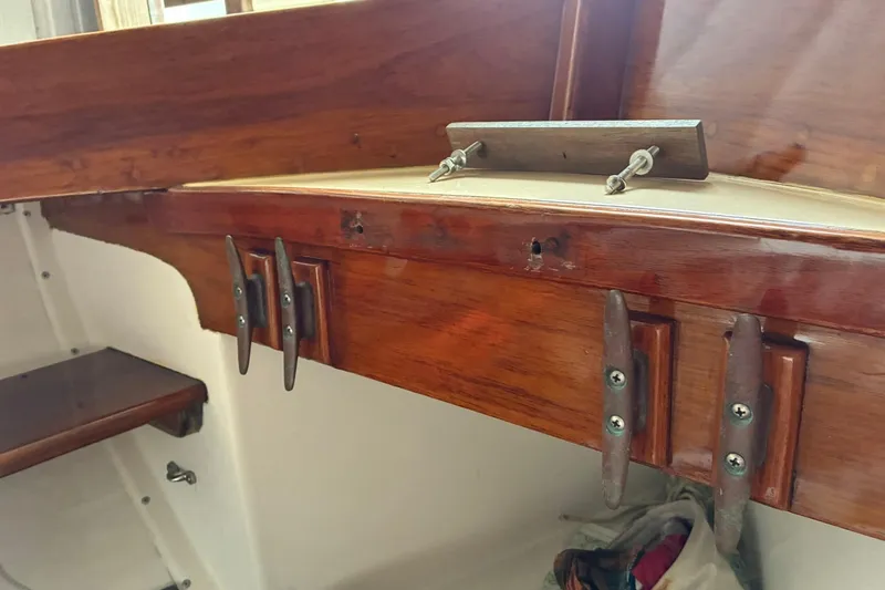 Slide: The Image of Interior view of a 1981 Herreshoff Doughdish 12.5 footer, showcasing polished wooden fittings. - 9