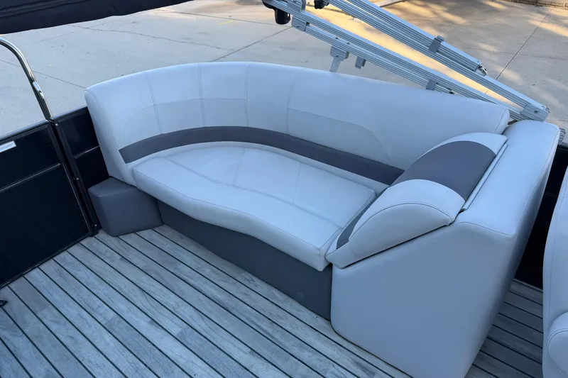 Slide: The Image of 2017 Crest I 220 SLC boat interior with sleek white seating on wooden deck. - 11