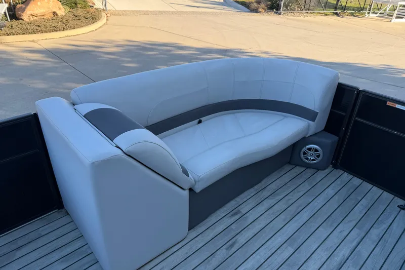 Slide: The Image of 2017 Crest I 220 SLC boat interior with gray seating on wooden deck. - 12