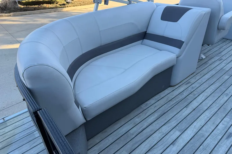 Slide: The Image of 2017 Crest I 220 SLC boat with gray seating on wooden deck. - 15