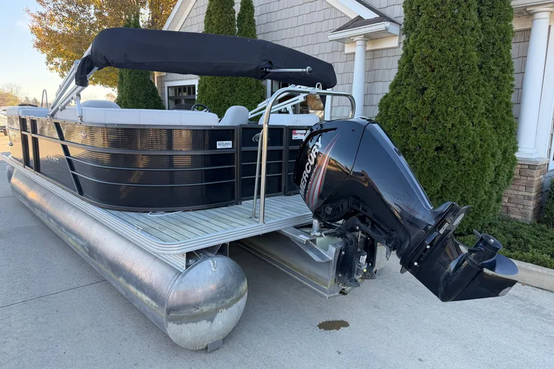 Slide: The Image of 2017 Crest I 220 SLC pontoon boat with Mercury outboard motor, parked on driveway. - 17