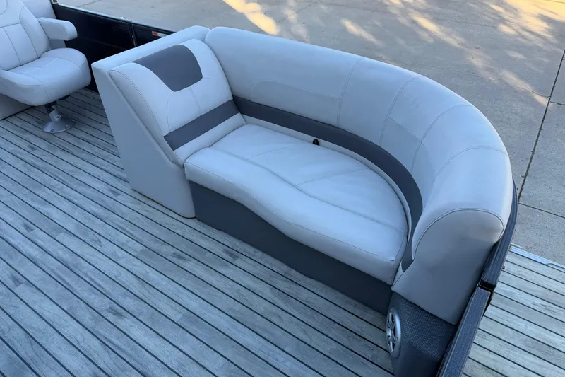 Slide: The Image of 2017 Crest I 220 SLC boat interior with gray seating on wooden deck. - 3
