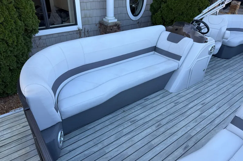 Slide: The Image of 2017 Crest I 220 SLC boat with white seating on a wooden deck. - 4