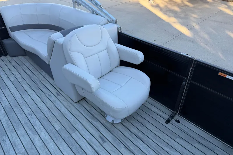 Slide: The Image of 2017 Crest I 220 SLC boat interior with plush seating on wooden deck. - 5