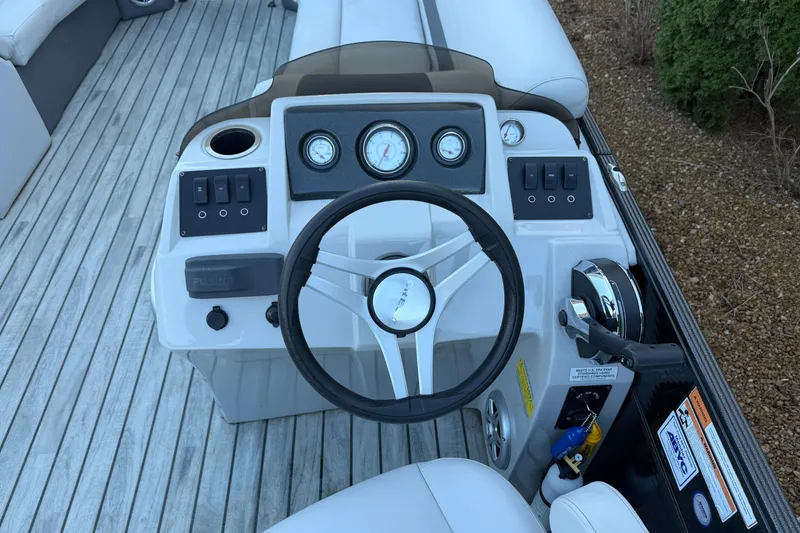 Slide: The Image of Steering console of 2017 Crest I 220 SLC pontoon boat with gauges and controls. - 8