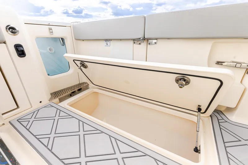 Slide: The Image of 2024 Scout 377 LXF boat storage compartment with open hatch, showcasing interior design. - 15