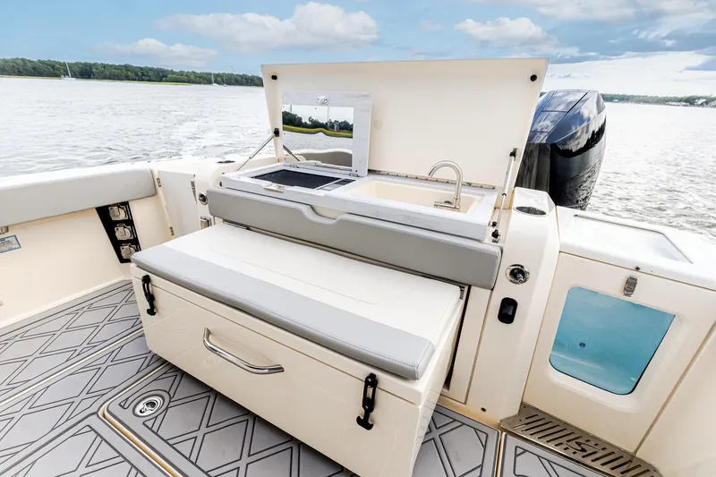 Slide: The Image of 2024 Scout 377 LXF boat interior with Summer Kitchen Upgrade featuring Electric Grill, Sink, Cutting Board and Slide out Cooler/Seat - 17
