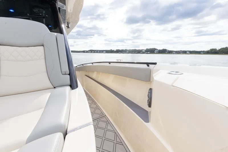 Slide: The Image of 2024 Scout 377 LXF boat interior with luxurious seating and scenic water view. - 39