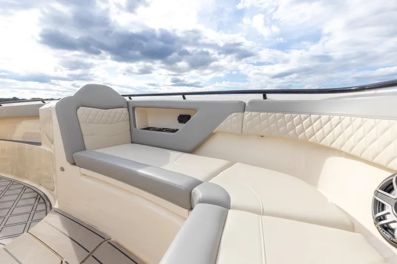 Slide: The Image of 2024 Scout 377 LXF boat interior with luxurious seating and elegant design under a cloudy sky. - 50