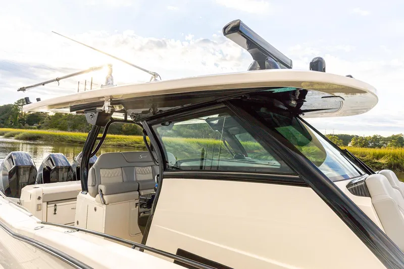 Slide: The Image of 2024 Scout 377 LXF boat with sleek design and modern features, docked by the water. - 70
