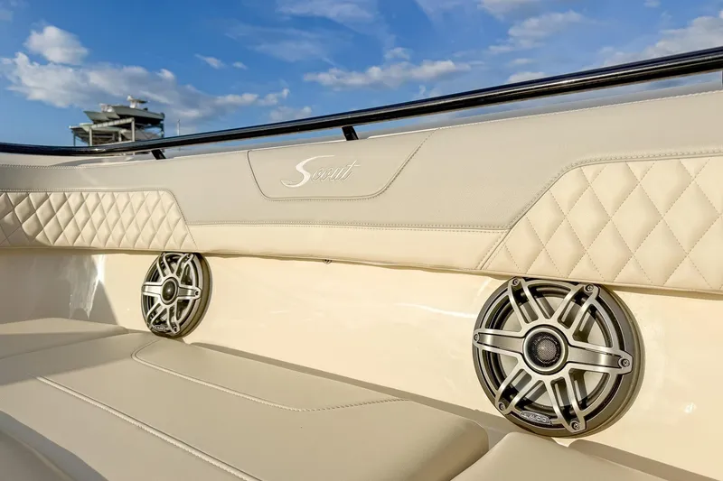 Slide: The Image of 2024 Scout 377 LXF boat interior with luxury seating and built-in speakers. - 74