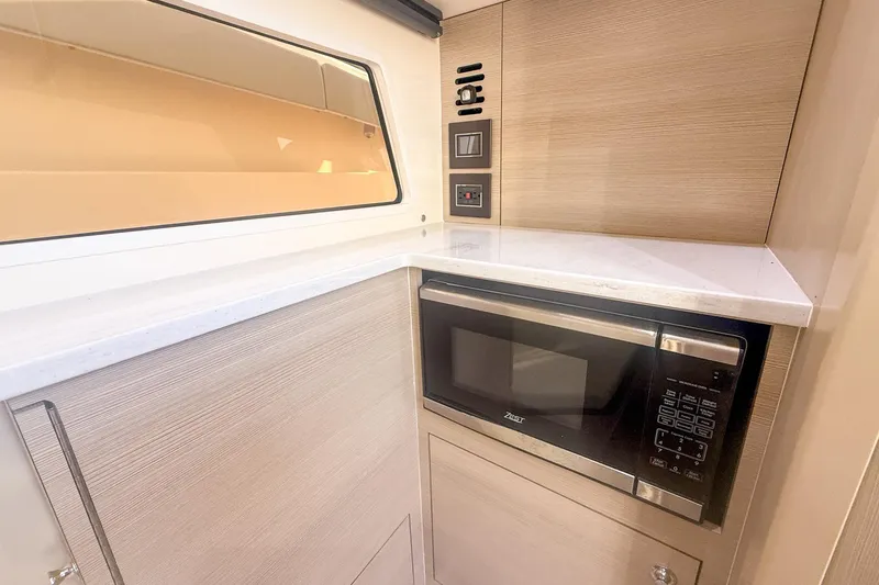 Slide: The Image of 2024 Scout 377 LXF interior with microwave and modern cabinetry. - 81