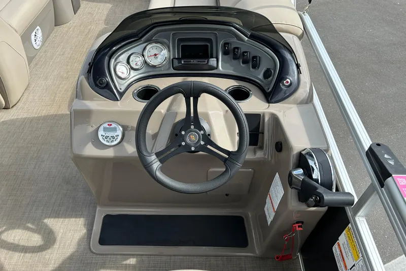 Slide: The Image of 2023 Sun Tracker Party Barge 20 DLX steering console with gauges and controls. - 10