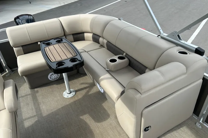 Slide: The Image of 2023 Sun Tracker Party Barge 20 DLX interior with beige seating and table. - 11