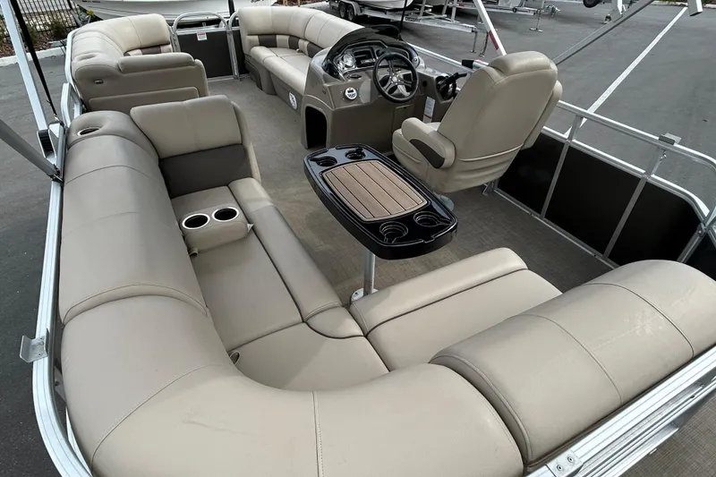Slide: The Image of 2023 Sun Tracker Party Barge 20 DLX interior with plush seating and steering console. - 13