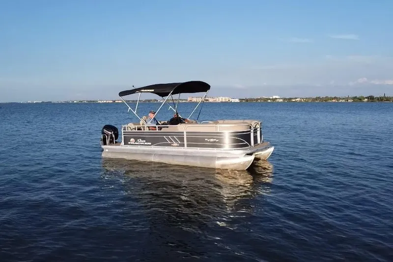 Slide: The Image of 2023 Sun Tracker Party Barge 20 DLX pontoon boat on calm water. - 16