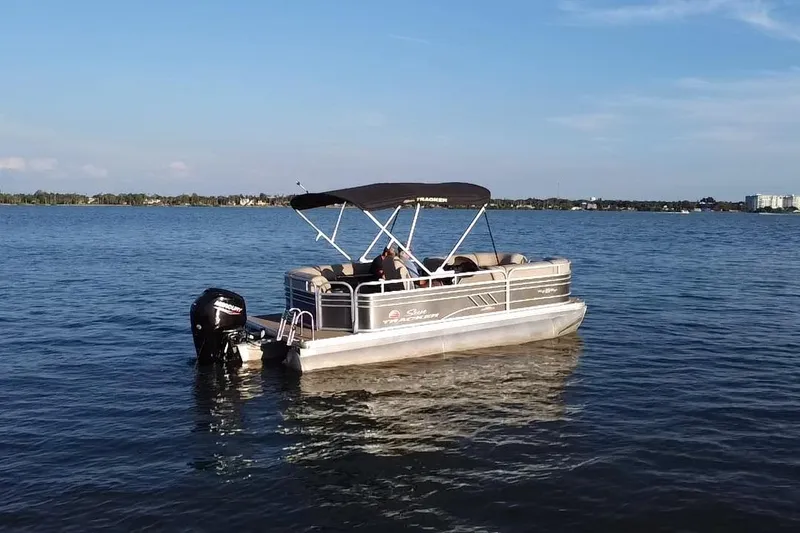 Slide: The Image of 2023 Sun Tracker Party Barge 20 DLX pontoon boat on a calm lake. - 17
