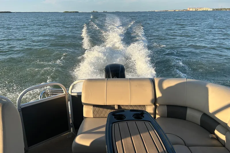 Slide: The Image of 2023 Sun Tracker Party Barge 20 DLX cruising on open water, showcasing comfortable seating. - 18