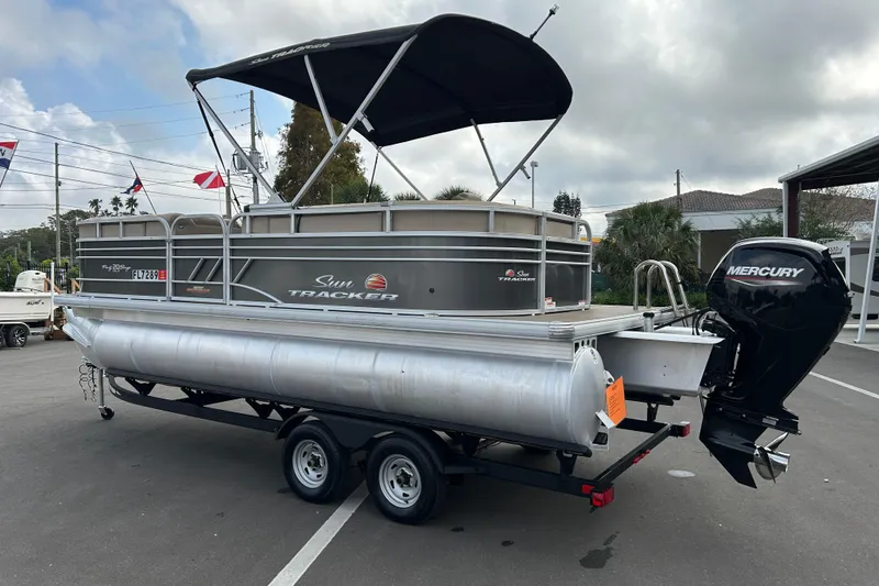 Slide: The Image of 2023 Sun Tracker Party Barge 20 DLX pontoon boat with Mercury engine on trailer. - 4
