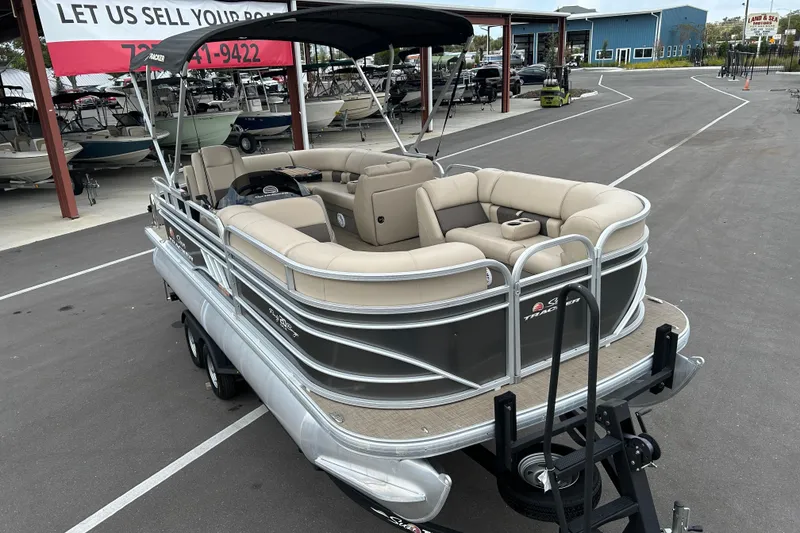 Slide: The Image of 2023 Sun Tracker Party Barge 20 DLX pontoon boat with beige seating and canopy. - 6