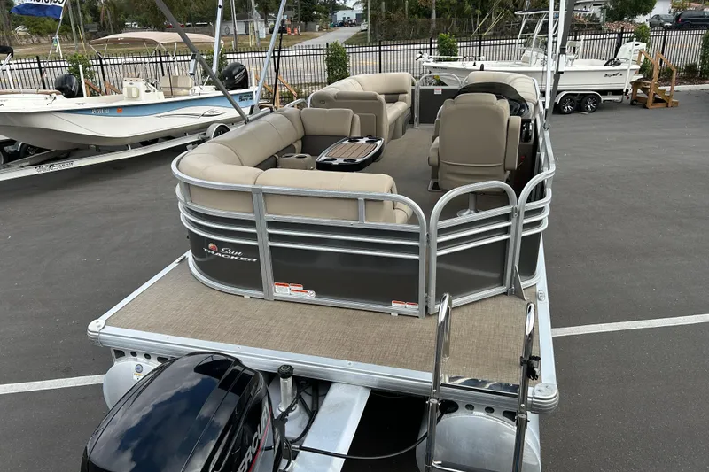 Slide: The Image of 2023 Sun Tracker Party Barge 20 DLX pontoon boat with beige seating and outboard motor. - 7
