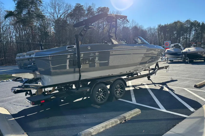 Slide: The Image of 2026 Supreme S240 boat on trailer in sunny parking lot. - 3
