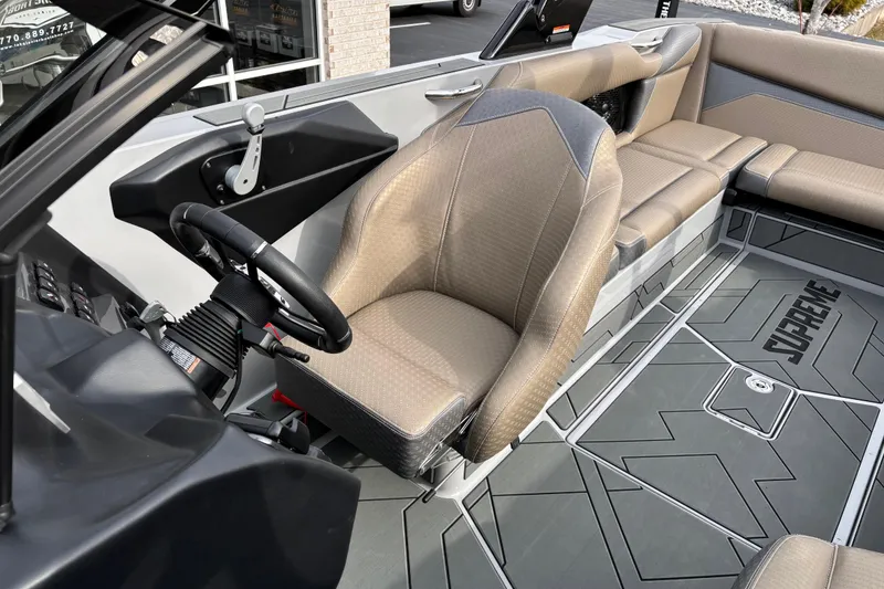 Slide: The Image of 2026 Supreme S240 boat interior with steering wheel and seating. - 9
