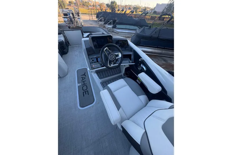 Slide: The Image of 2026 Tahoe Pontoon CASCADE QUAD LOUNGER interior with modern steering and seating. - 3