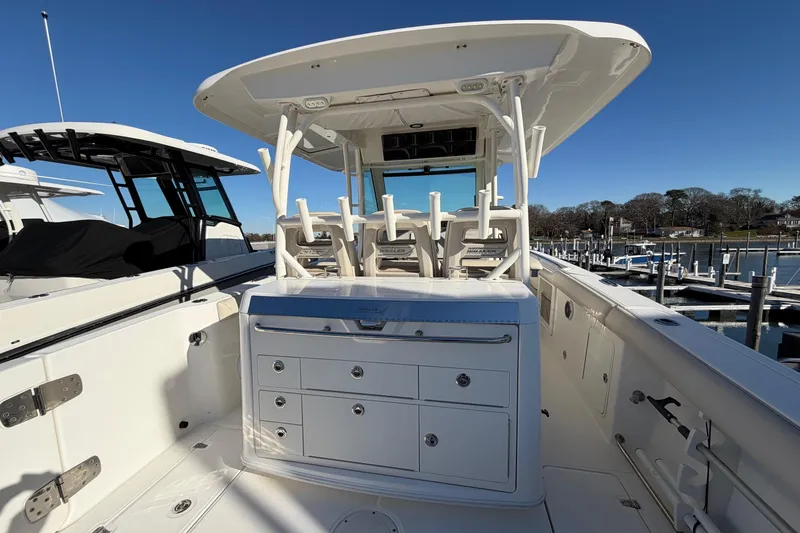 Slide: The Image of 2017 Boston Whaler 350 Outrage boat interior with seating and storage, docked at marina. - 12