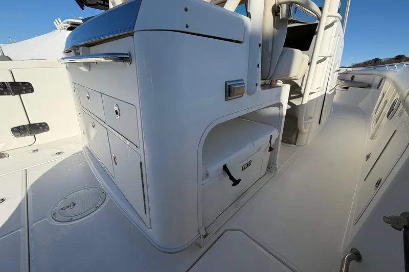 Slide: The Image of 2017 Boston Whaler 350 Outrage interior with storage and Yeti cooler. - 18
