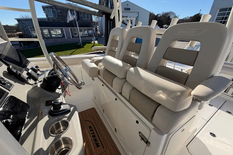 Slide: The Image of 2017 Boston Whaler 350 Outrage cockpit with helm, seating, and controls. - 19