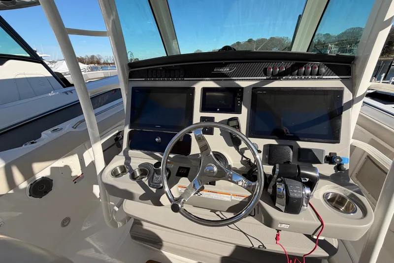 Slide: The Image of 2017 Boston Whaler 350 Outrage helm with dual screens and modern controls. - 22