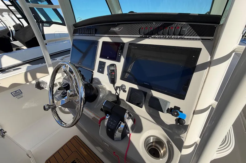 Slide: The Image of 2017 Boston Whaler 350 Outrage helm with steering wheel and navigation displays. - 23