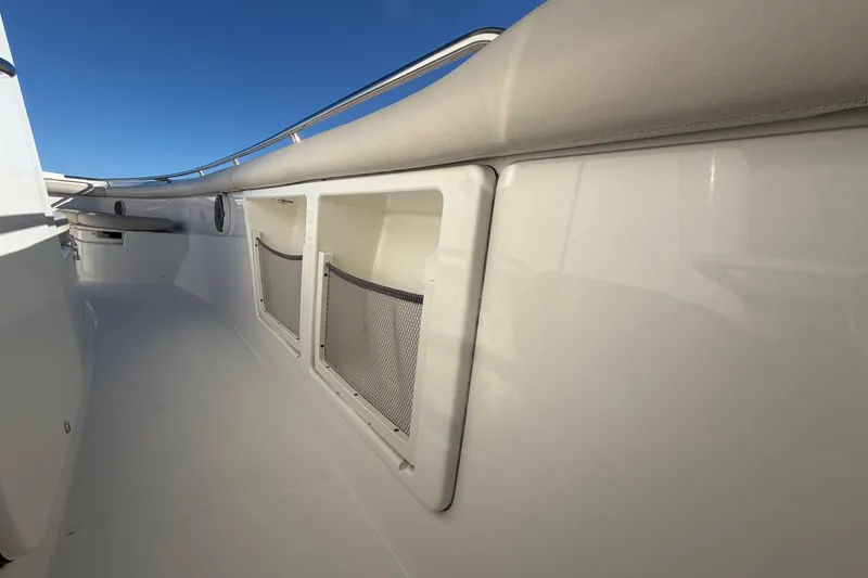 Slide: The Image of 2017 Boston Whaler 350 Outrage cabin interior with sink, toilet, and wooden cabinetry. - 27