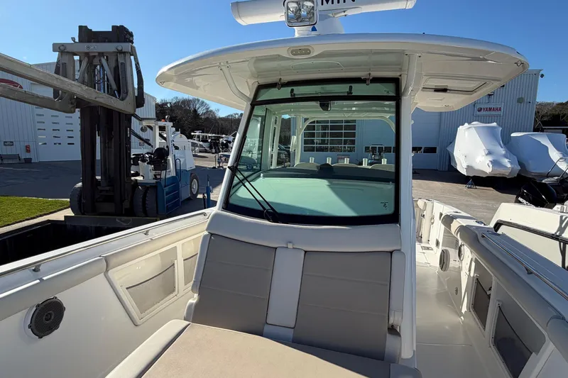 Slide: The Image of 2017 Boston Whaler 350 Outrage boat interior with seating and table, docked at marina. - 30