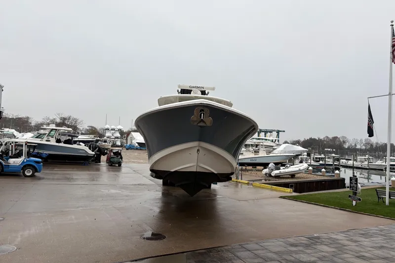 Slide: The Image of 2017 Boston Whaler 350 Outrage anchor compartment with chain and rope at dock. - 34
