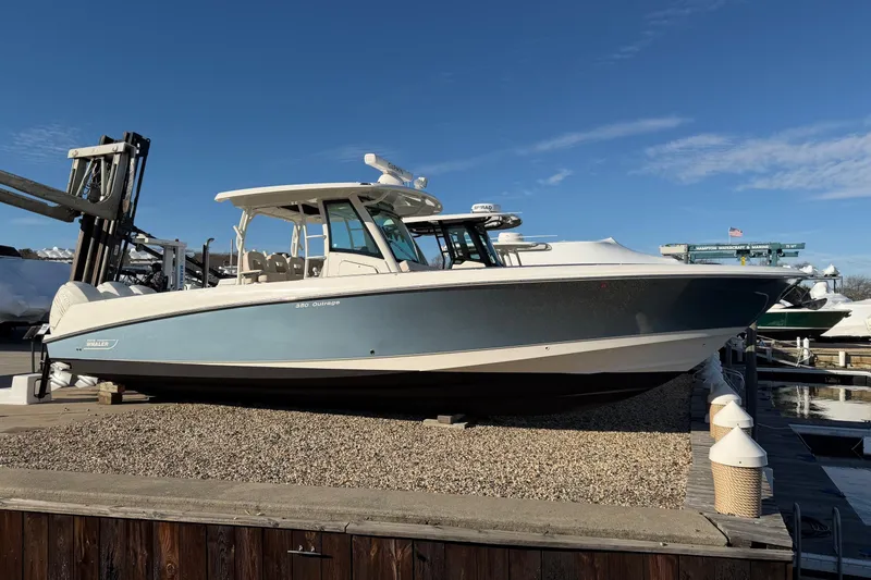 Slide: The Image of 2017 Boston Whaler 350 Outrage boat at marina, front view, overcast day. - 35